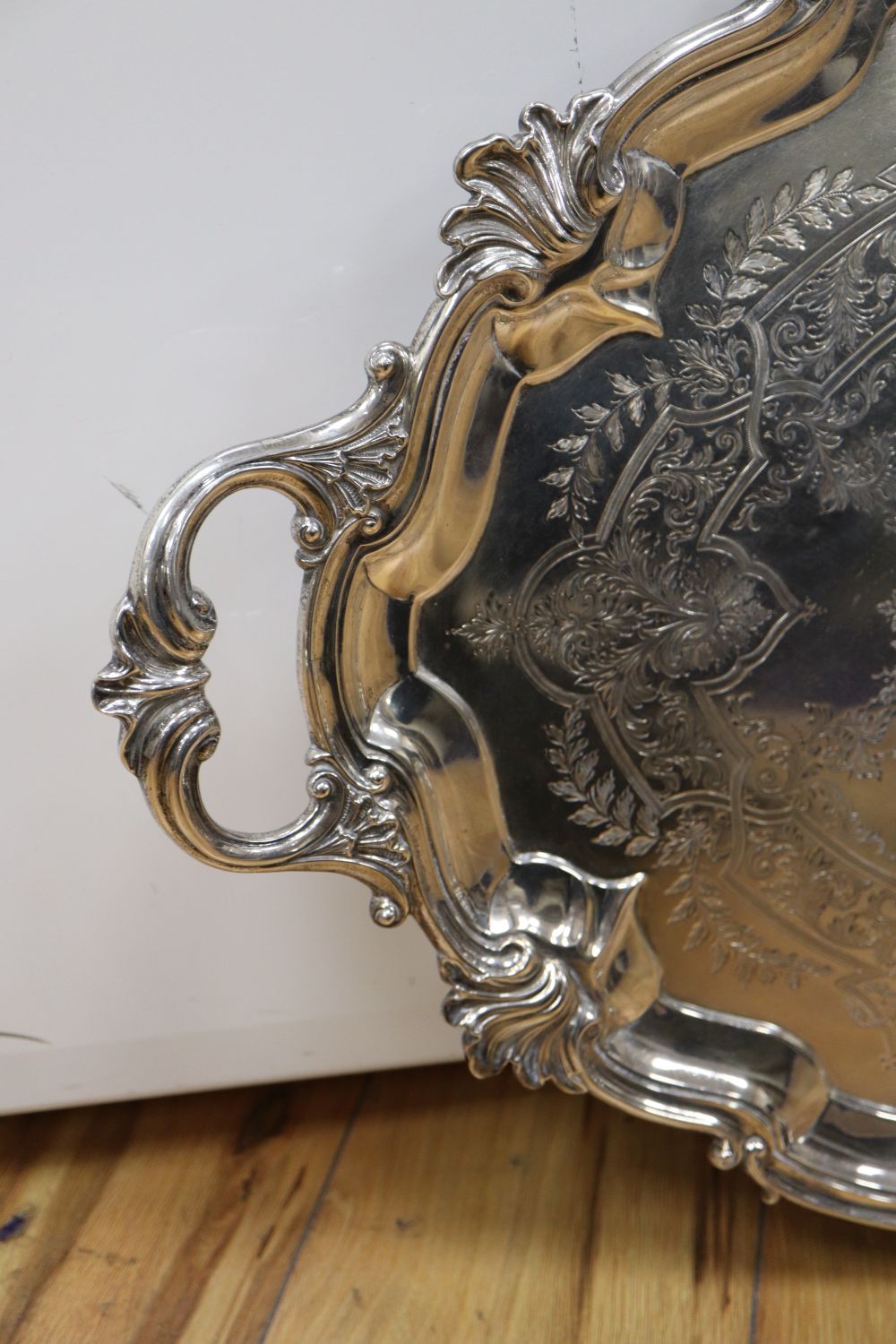 A large shaped oval silver two-handled tray with shell and scroll border, approx 116oz